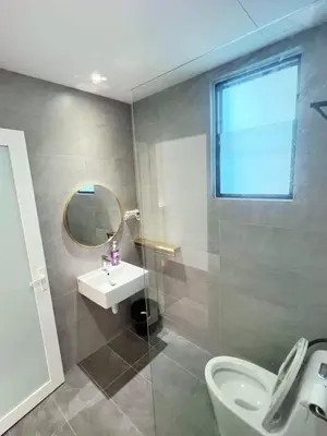a bathroom with a sink and a toilet and a mirror at Taste of Home in Ipoh