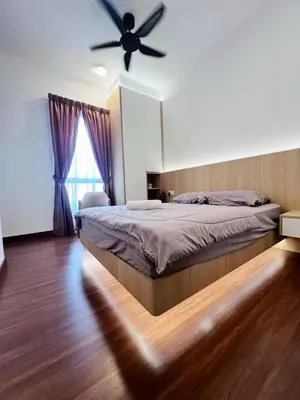 a bedroom with a bed with a ceiling fan at Taste of Home in Ipoh