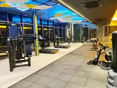 a gym with rows of treadmills and machines at Taste of Home in Ipoh