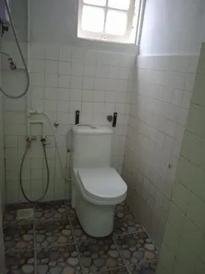 a bathroom with a toilet and a shower at Cool view hotel in Tanah Rata