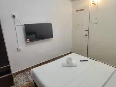 a white room with a tv on a wall at Cool view hotel in Tanah Rata