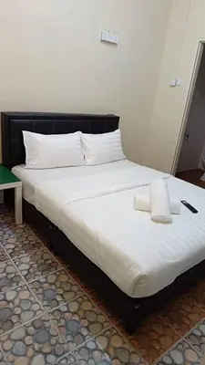 a large bed with two towels on it in a room at Cool view hotel in Tanah Rata