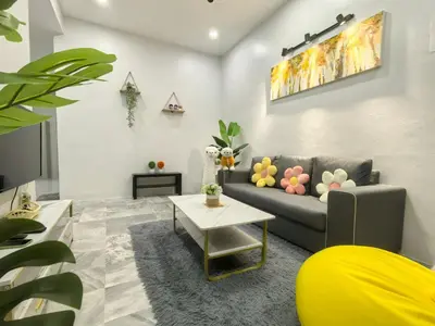 a living room with a couch and a table at 32 Homestay in Teluk Intan