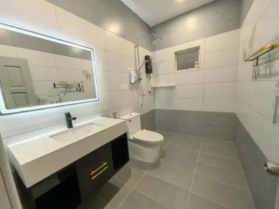 a bathroom with a sink and a toilet and a mirror at 32 Homestay in Teluk Intan