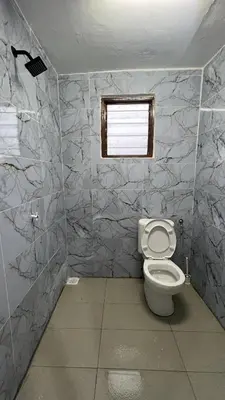 a bathroom with a toilet and a window at Villa Alyana in Ipoh