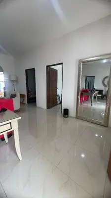 a living room with a large mirror on the floor at Villa Alyana in Ipoh