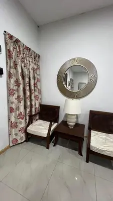 a room with two chairs and a mirror at Villa Alyana in Ipoh