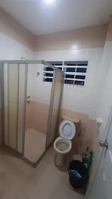 a bathroom with a toilet and a shower and a window at Glory Homestay Ipoh in Ipoh