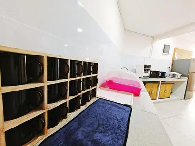 a room with a room with a blue rug and a kitchen at 45GeorgeTown Multi Family corner lot free parking food convenience stores nearby in George Town