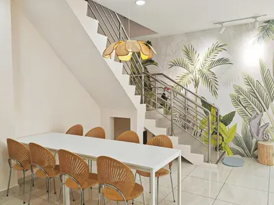a dining room with a table and chairs and a staircase at 45GeorgeTown Multi Family corner lot free parking food convenience stores nearby in George Town
