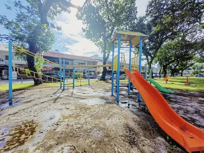 a playground in a park with a slide at 45GeorgeTown Multi Family corner lot free parking food convenience stores nearby in George Town