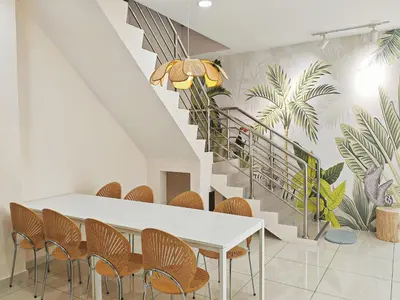 a dining room with a table and chairs and a staircase at 45GeorgeTown Multi Family corner lot free parking food convenience stores nearby in George Town
