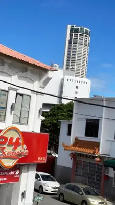 a building with cars parked in front of it with a tall building at Heritage House 123 in George Town