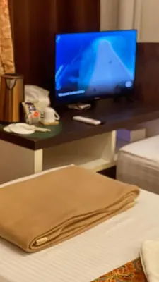 a desk with a laptop computer on top of a bed at Heritage House 123 in George Town