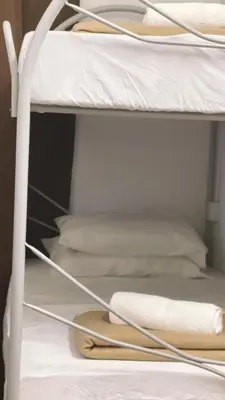 a bunk bed with pillows and towels on it at Heritage House 123 in George Town