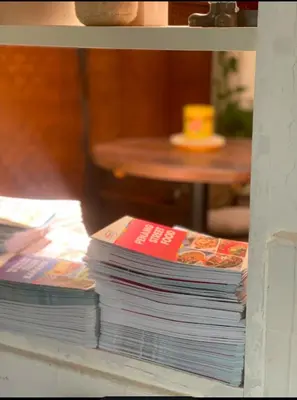 a stack of magazines sitting on a shelf at Heritage House 123 in George Town