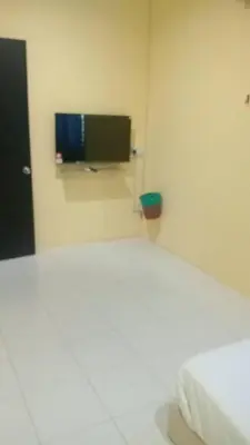 a room with a bed and a tv on the wall at Dynamic homes stay in Ipoh