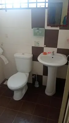 a bathroom with a toilet and a sink at Dynamic homes stay in Ipoh