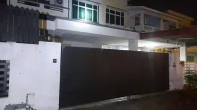 a black gate in front of a house at night at Dynamic homes stay in Ipoh