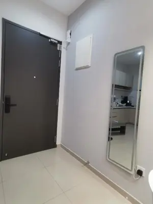 a large black door in a room with a mirror at Iconic Regency Service Residences - Xin's Home in Bayan Lepas