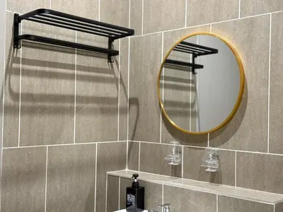 a bathroom with a mirror and a sink at Iconic Regency Service Residences - Xin's Home in Bayan Lepas