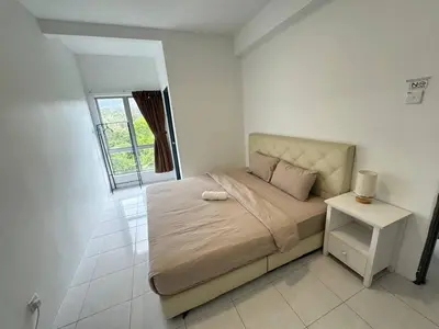 a white bedroom with a bed and a window at Eisya Homestay 2 at Emerald Avenue Brinchang in Brinchang