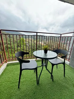 a patio with two chairs and a table on a balcony at Eisya Homestay 2 at Emerald Avenue Brinchang in Brinchang