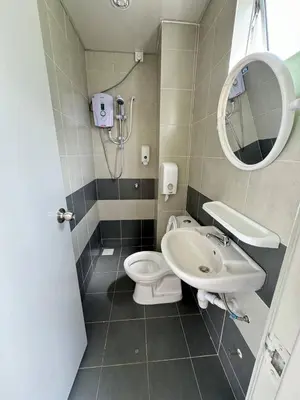 a bathroom with a toilet and a sink and a mirror at Eisya Homestay 2 at Emerald Avenue Brinchang in Brinchang