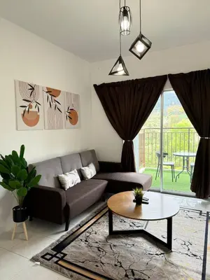 a living room with a couch and a table at Eisya Homestay 2 at Emerald Avenue Brinchang in Brinchang