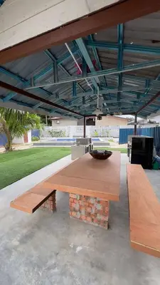 a wooden table with a bowl on top of it at Villa Alyana in Ipoh