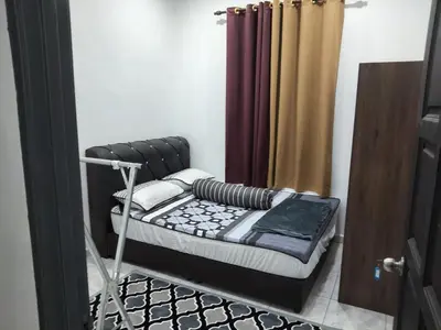 a bunk bed in a room with a curtain at Tasmie homestay in Butterworth