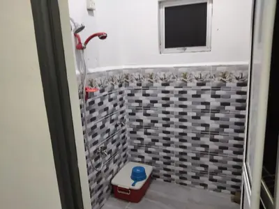 a bathroom with a shower with a toilet and a window at Tasmie homestay in Butterworth