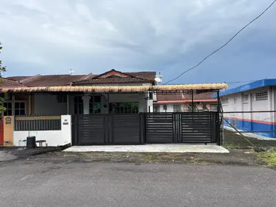 a house with a gate in front of it at Rafeeqs Homestay in Teluk Intan