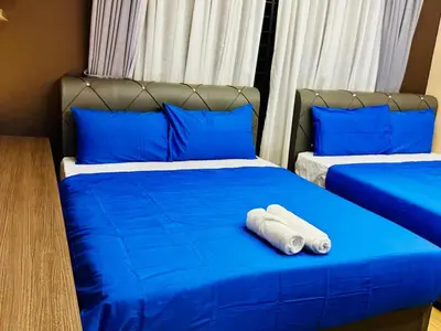 a bedroom with two beds with blue sheets and blue pillows at Opulent Villa for 20pax BBQ, Steps to Beach Market in Batu Ferringhi