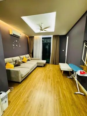 a living room with a couch and a ceiling fan at Opulent Villa for 20pax BBQ, Steps to Beach Market in Batu Ferringhi