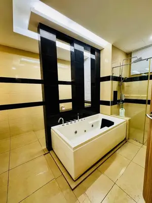 a bathroom with a large tub in a room at Opulent Villa for 20pax BBQ, Steps to Beach Market in Batu Ferringhi