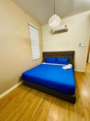 a bedroom with a blue bed in a room at Opulent Villa for 20pax BBQ, Steps to Beach Market in Batu Ferringhi