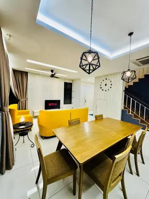 a dining room with a table and a yellow couch at Opulent Villa for 20pax BBQ, Steps to Beach Market in Batu Ferringhi