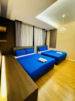 two beds in a room with blue sheets at Elegant20PaxVilla Perfect Location NearBeachMarket in Batu Ferringhi
