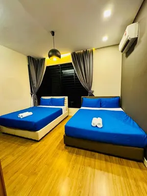 two beds in a room with blue sheets at Elegant20PaxVilla Perfect Location NearBeachMarket in Batu Ferringhi
