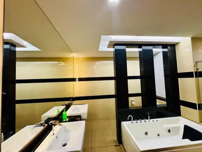 a bathroom with two sinks and a mirror at Elegant20PaxVilla Perfect Location NearBeachMarket in Batu Ferringhi