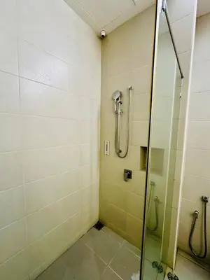 a bathroom with a shower with a glass door at Elegant20PaxVilla Perfect Location NearBeachMarket in Batu Ferringhi