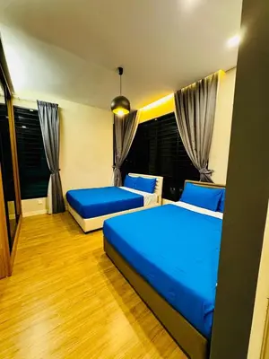 two beds in a room with blue sheets at Charming Luxury Villa 20,BBQ, Close to Beach Shops in Batu Ferringhi