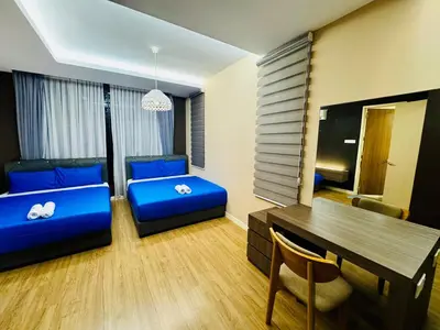 a living room with a blue couch and a table at Charming Luxury Villa 20,BBQ, Close to Beach Shops in Batu Ferringhi