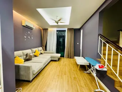 a living room with a couch and a staircase at Charming Luxury Villa 20,BBQ, Close to Beach Shops in Batu Ferringhi
