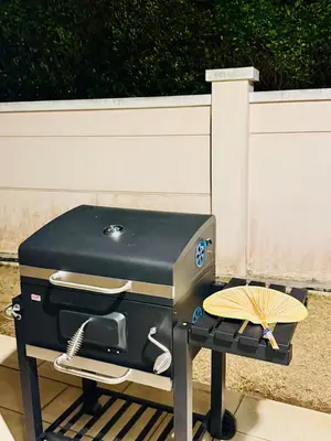 a grill sitting on a table with a fan at Beautiful 20-Person Villa, Walk to Beach & Market in Batu Ferringhi