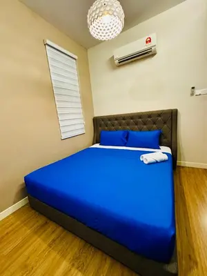 a bedroom with a large blue bed in a room at Beautiful 20-Person Villa, Walk to Beach & Market in Batu Ferringhi