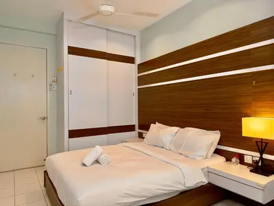 a bedroom with a large bed with a wooden headboard at Cozy Homestay in Karpal Singh by 3C in George Town