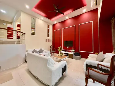 a living room with red walls and white furniture at Cozy Homestay in Karpal Singh by 3C in George Town