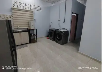 a room with two washing machines in a room at Homestay Zainab Sg Dua Mslim With 100mbps Wifi in Kepala Batas